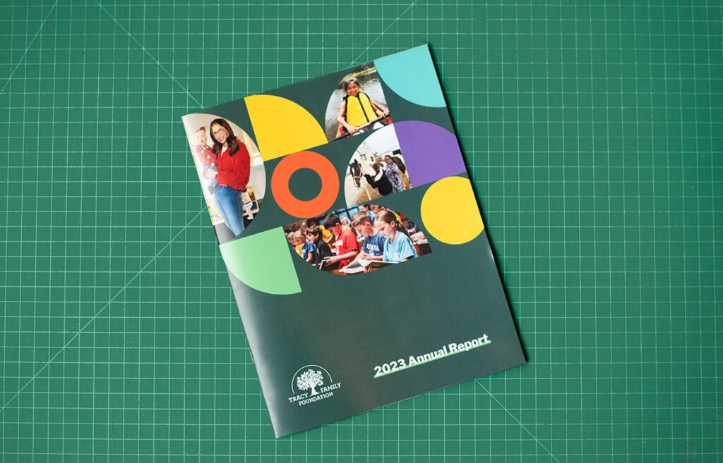 Annual report cover design for the Tracy Family Foundation on a green cutting mat